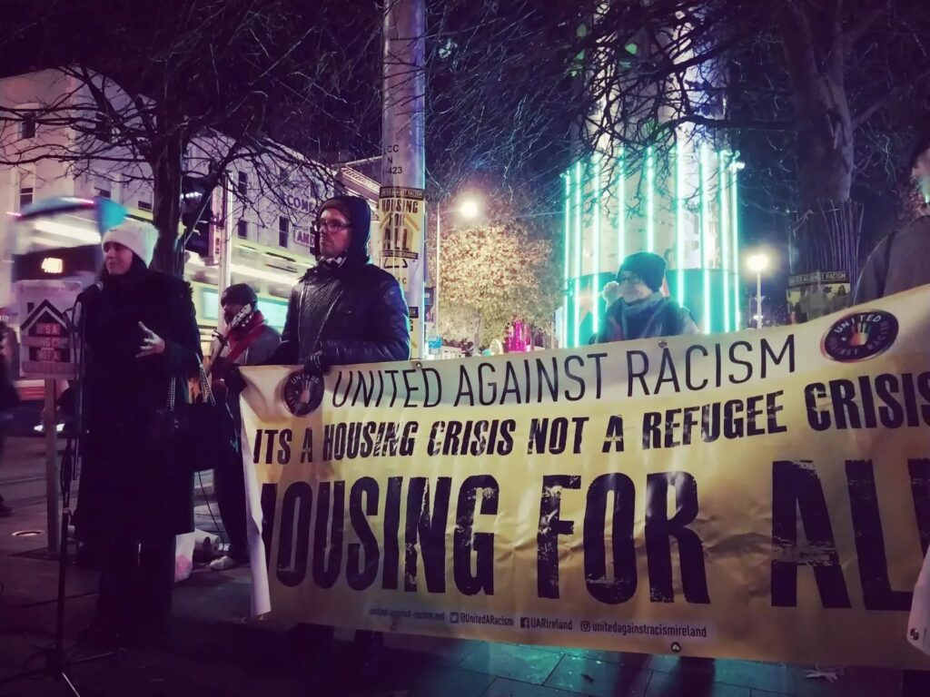 People holding a United Against Racism banner