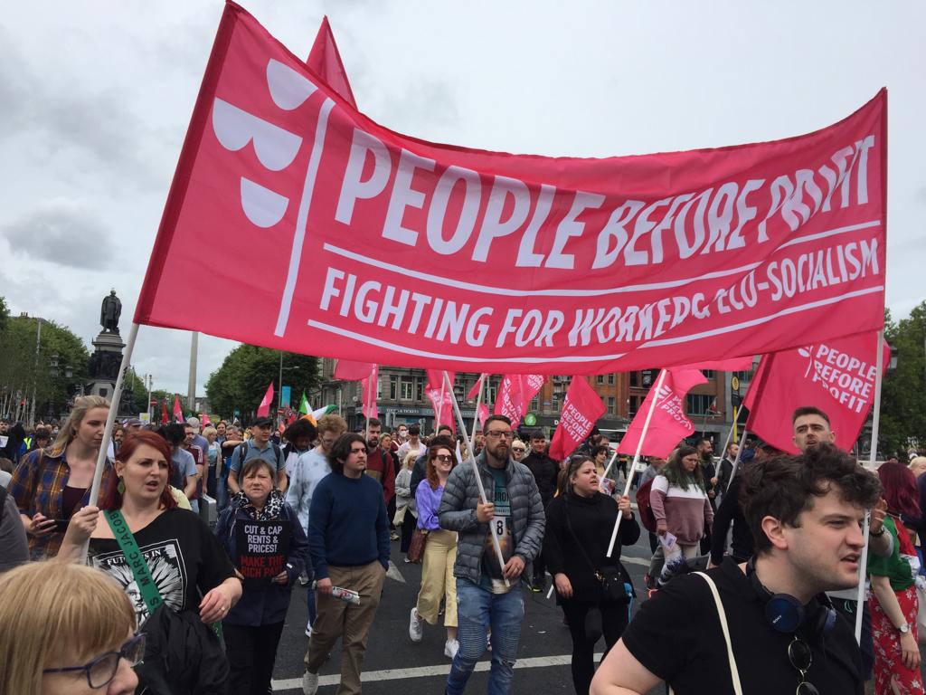 Picture from People Before Profit demo showing activists carrying People Before Profit flags