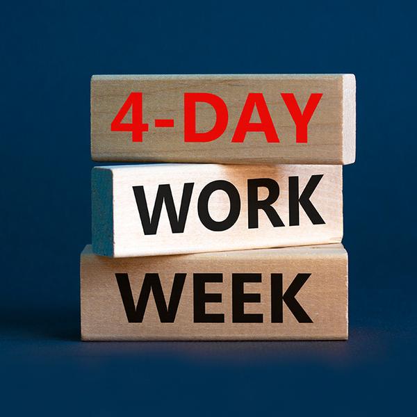3 wooden blocks with 4 day work week written on them
