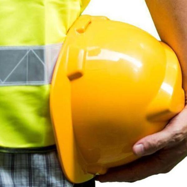Construction worker holding helmet