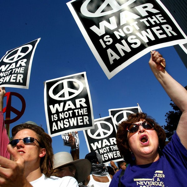 Protesters carrying placards with the message "War Is Not The Answer"