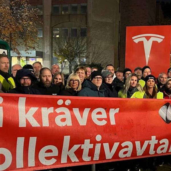 Protestors outside a Tesla factory in Sweden demanding a collective deal.